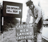 Man installing cataphote reflectors on a road